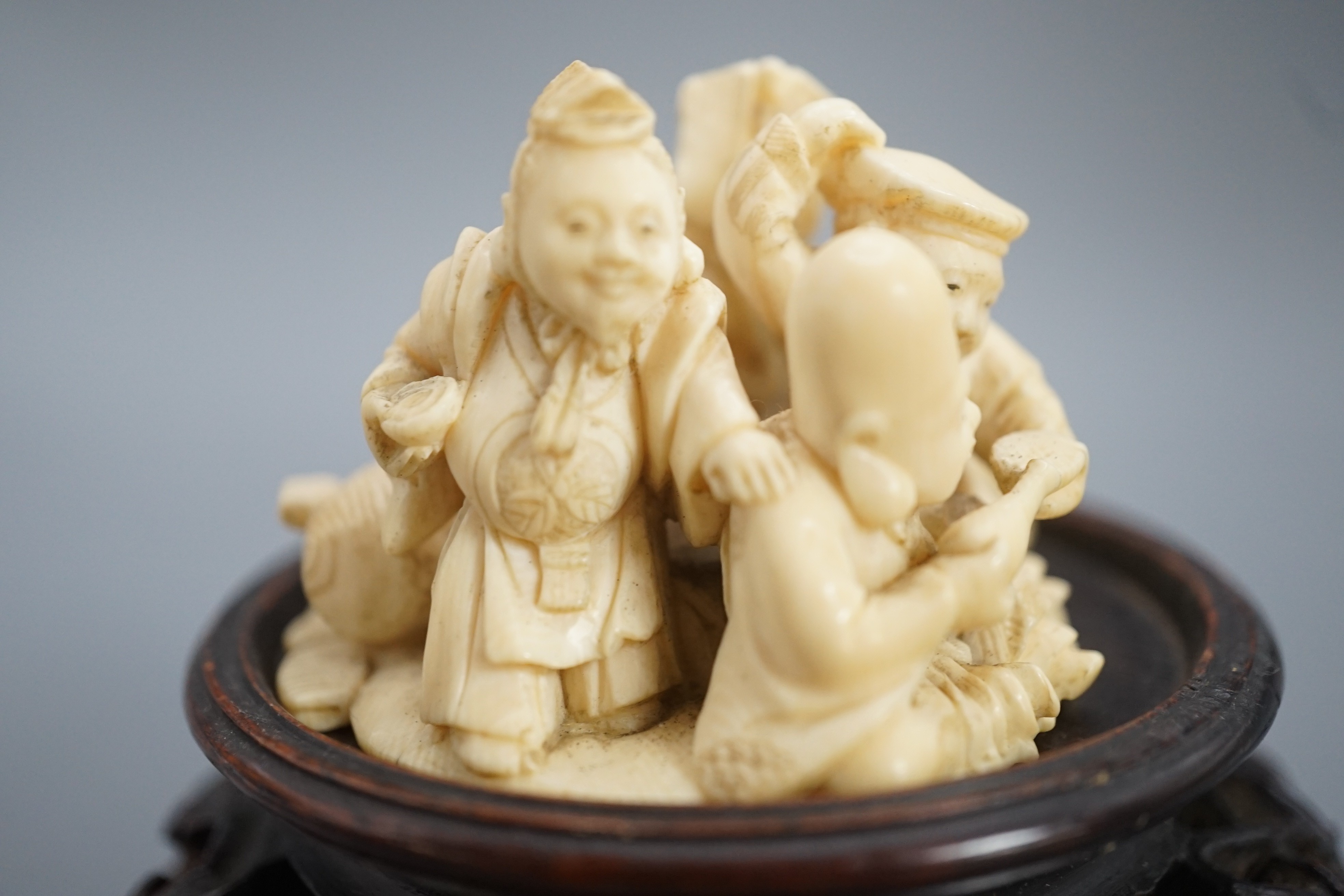 A Japanese ivory okimono of four of the Gods of Happiness, signed Gyokuzan, early 20th century, 6cm